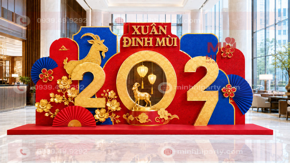 trang tri tieu canh tet 2027 cho sanh lon nha hang khach san uu tien Backdrop check-in Xuân Đinh Mùi 2027 tại sảnh lớn nhà hàng, khách sạn với linh vật dê và mô hình số năm nổi bật.